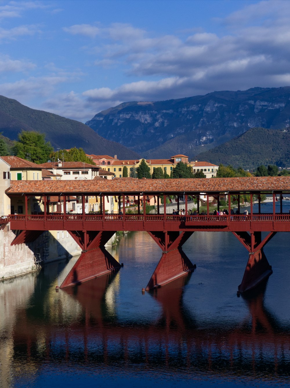 a bridge over a body of water with buildings in the background