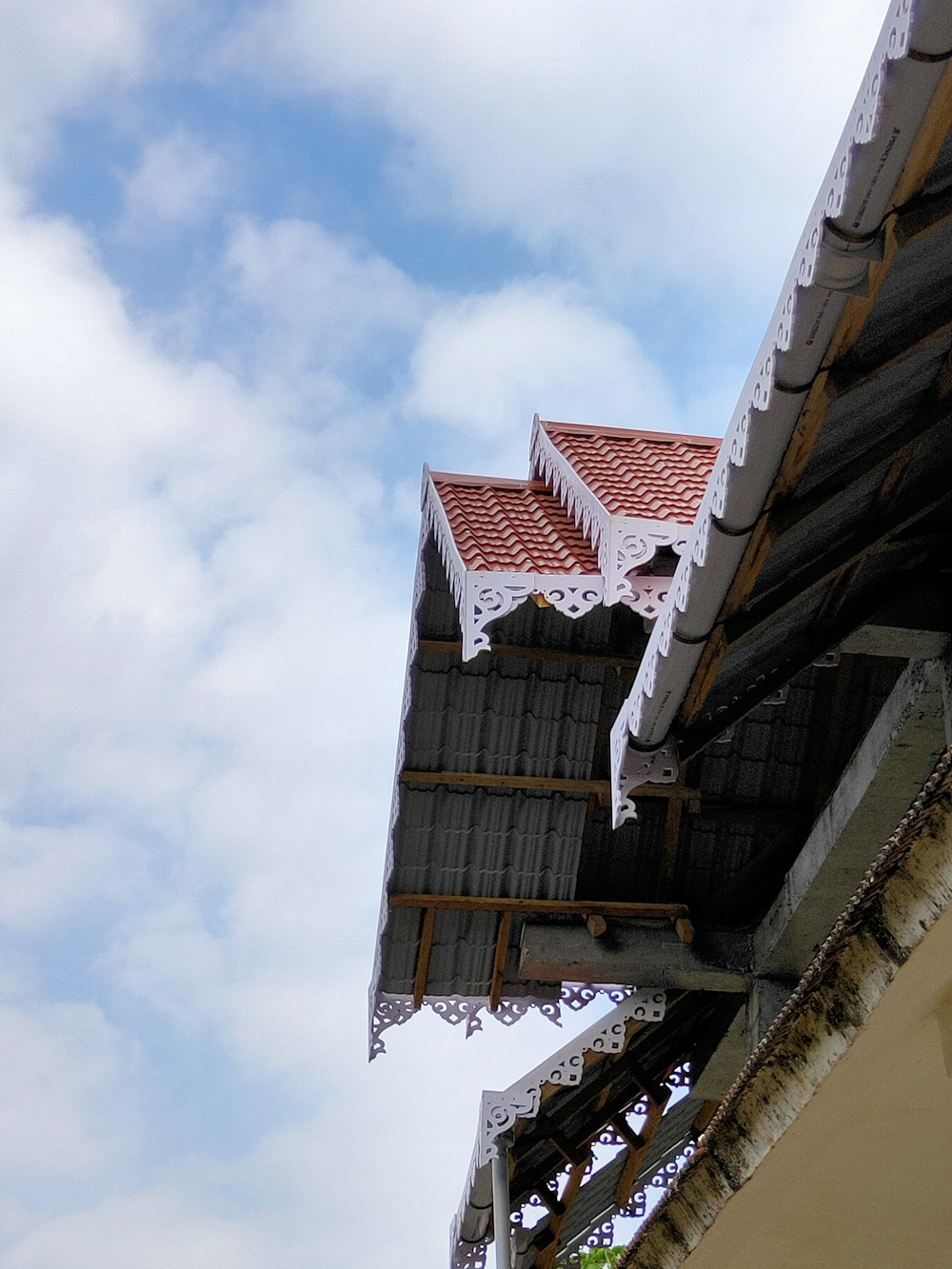 a bird is perched on the roof of a building