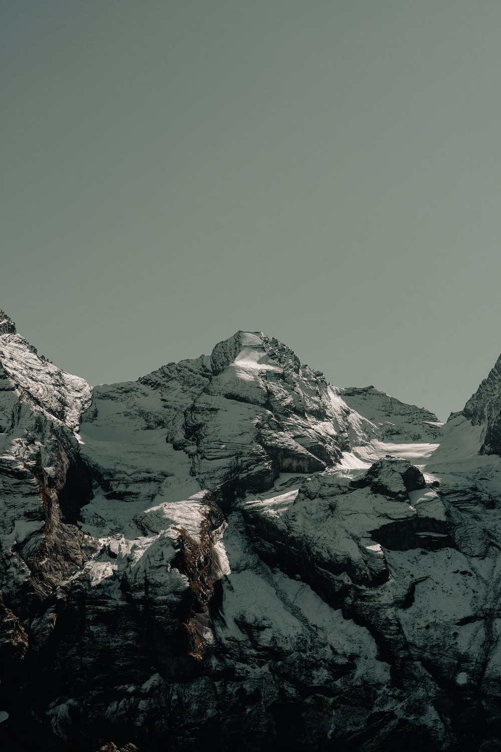 a black and white photo of snow covered mountains