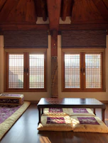Spacious non-AC room featuring traditional decor and natural light.