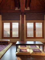 Cozy room with traditional Indian decor and a view of a nearby temple.