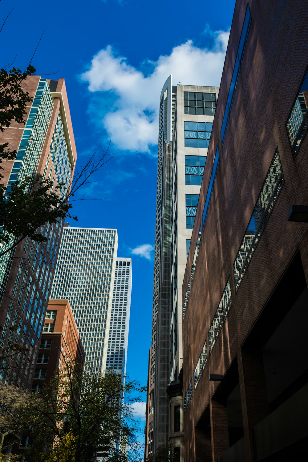 a city street with tall buildings and a blue sky