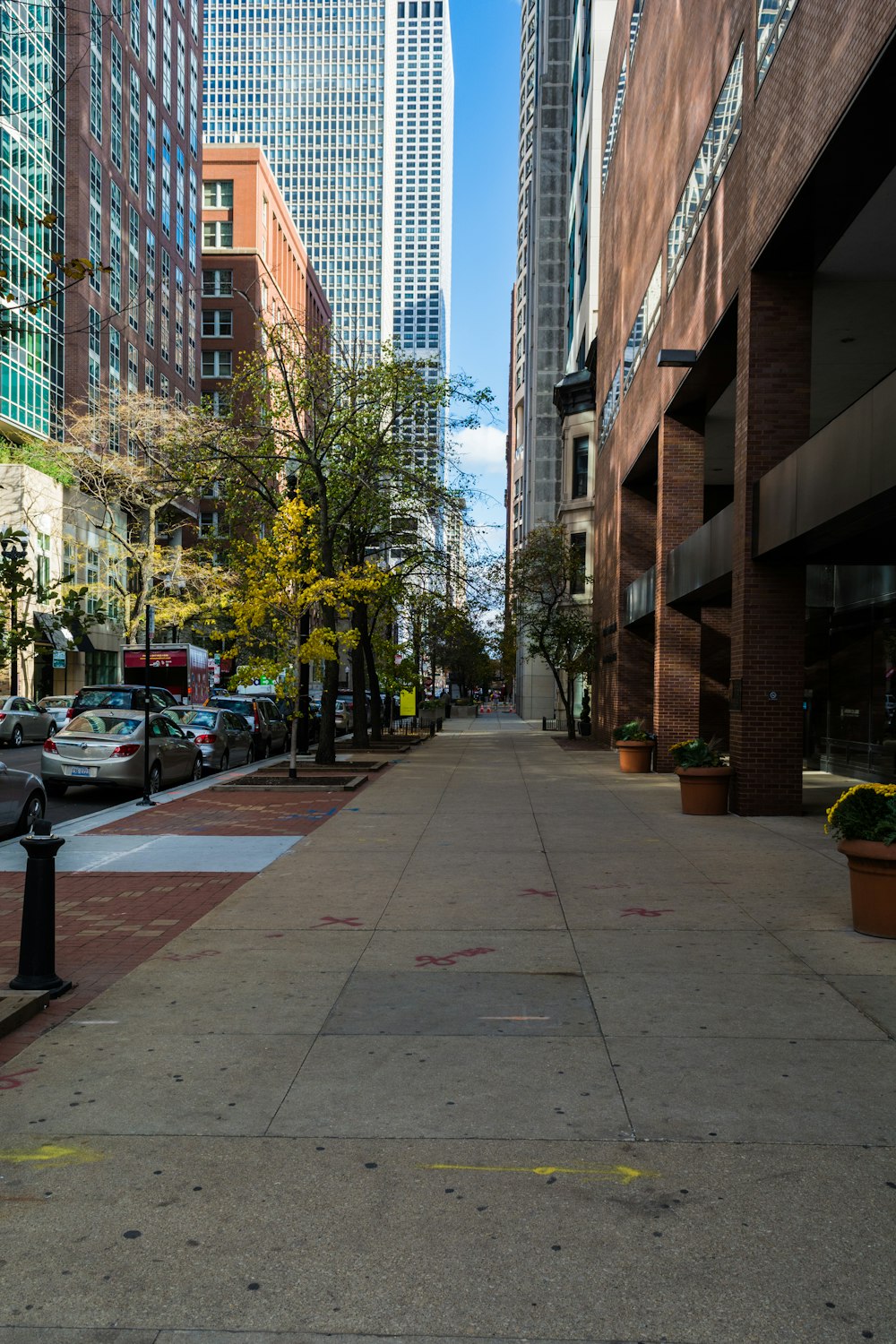 a city street lined with tall buildings and parked cars