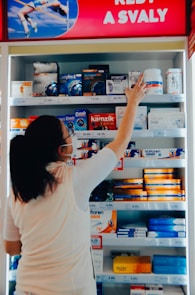 a woman reaching for a product in a store