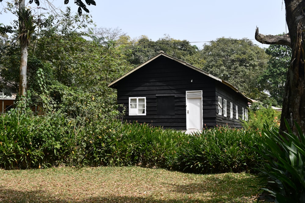 a black house with a white door and window