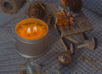 a lit candle sitting on top of a table