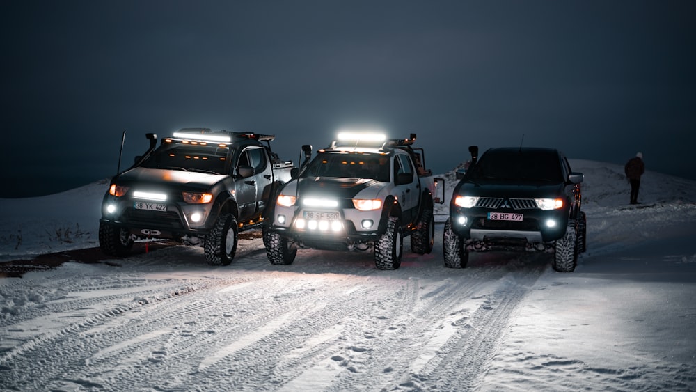 a couple of trucks that are sitting in the snow