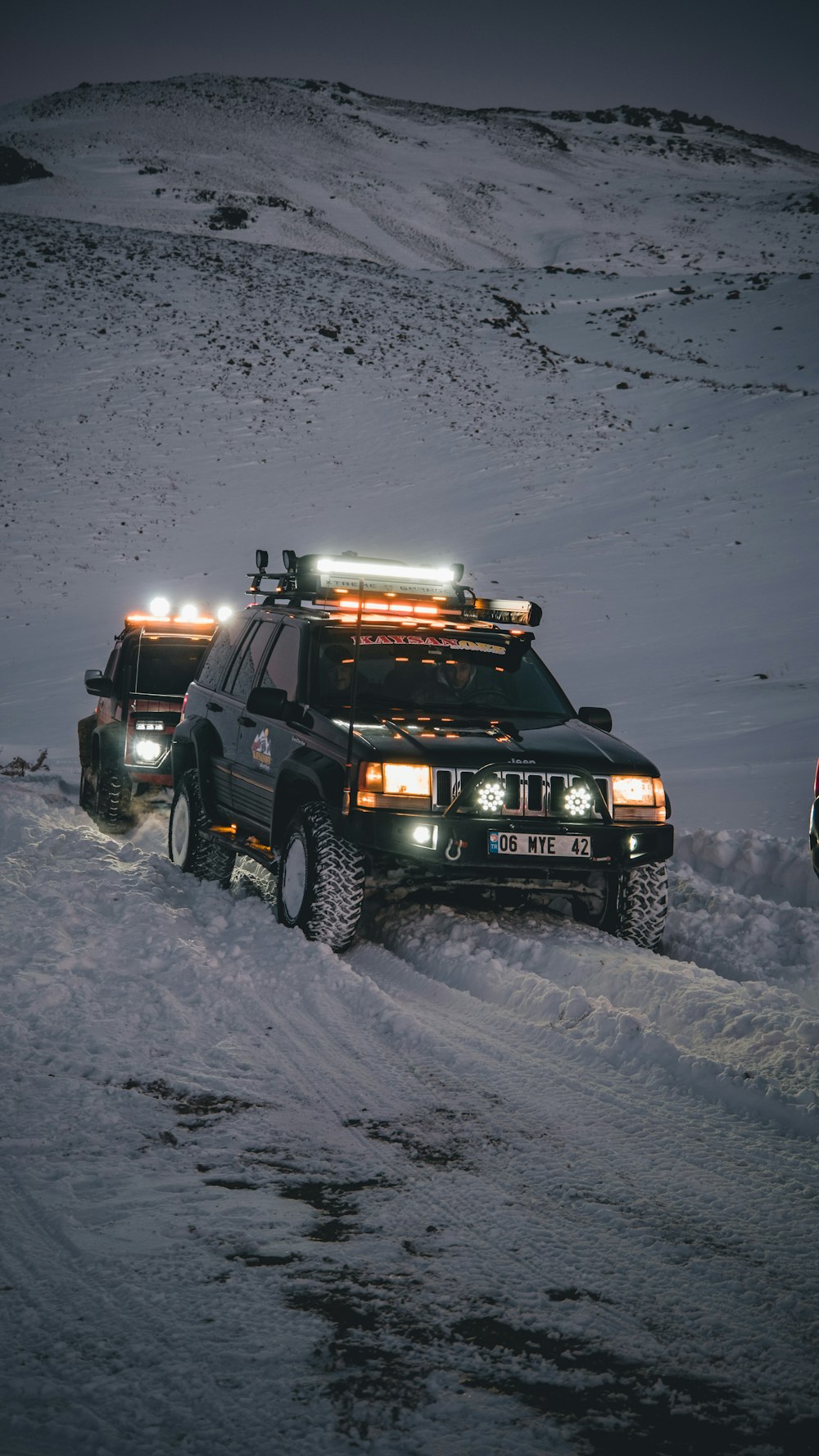 a couple of trucks that are in the snow