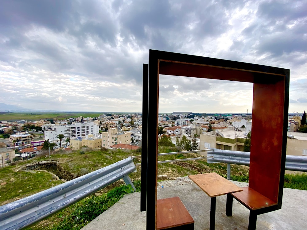 a wooden bench sitting on top of a cement slab