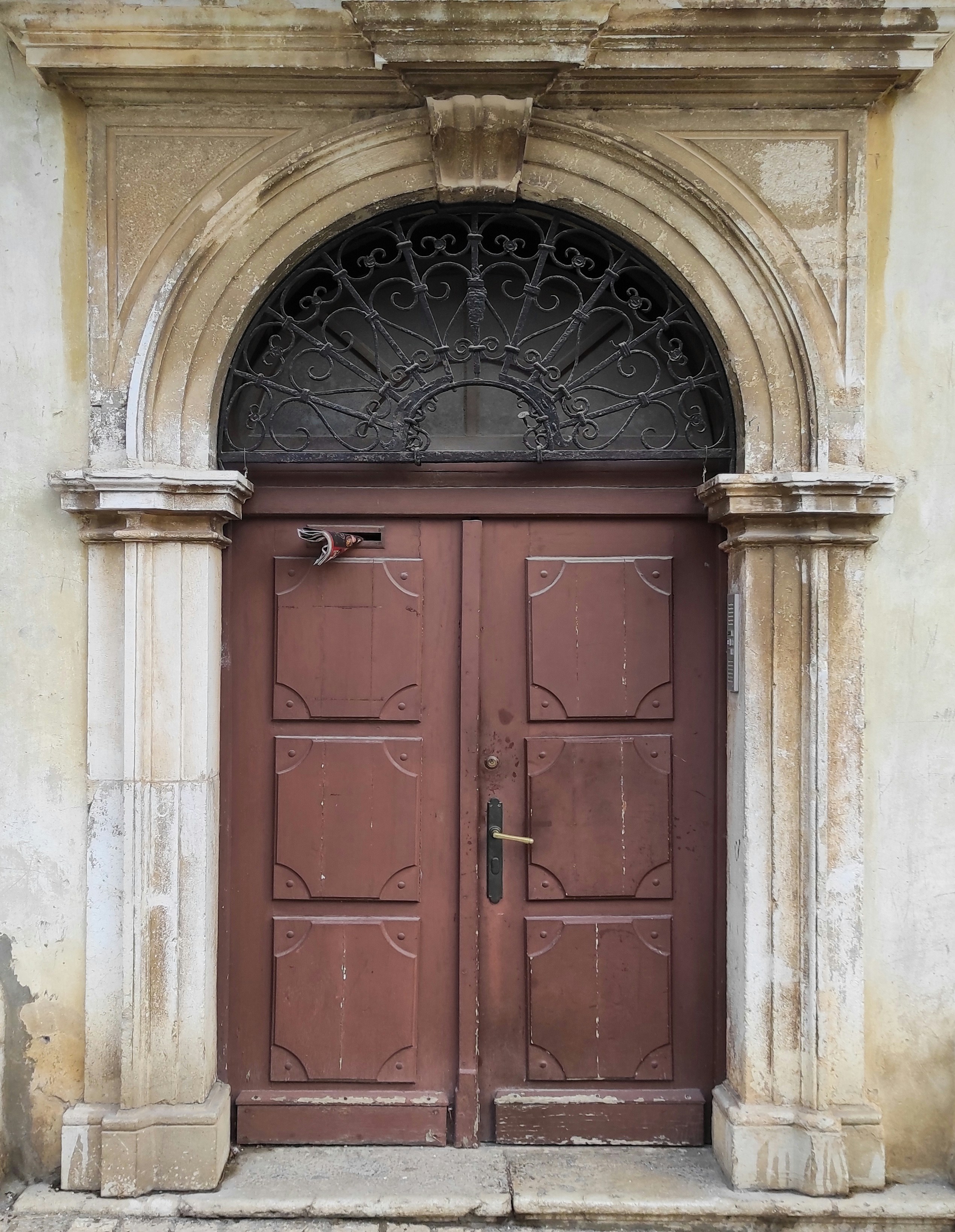 a couple of brown doors sitting inside of a building