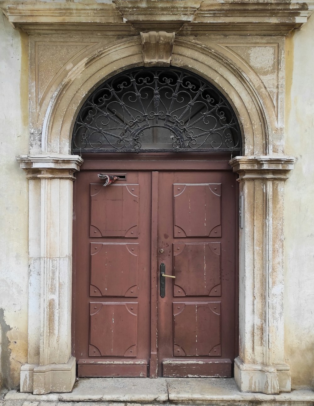 a couple of brown doors sitting inside of a building