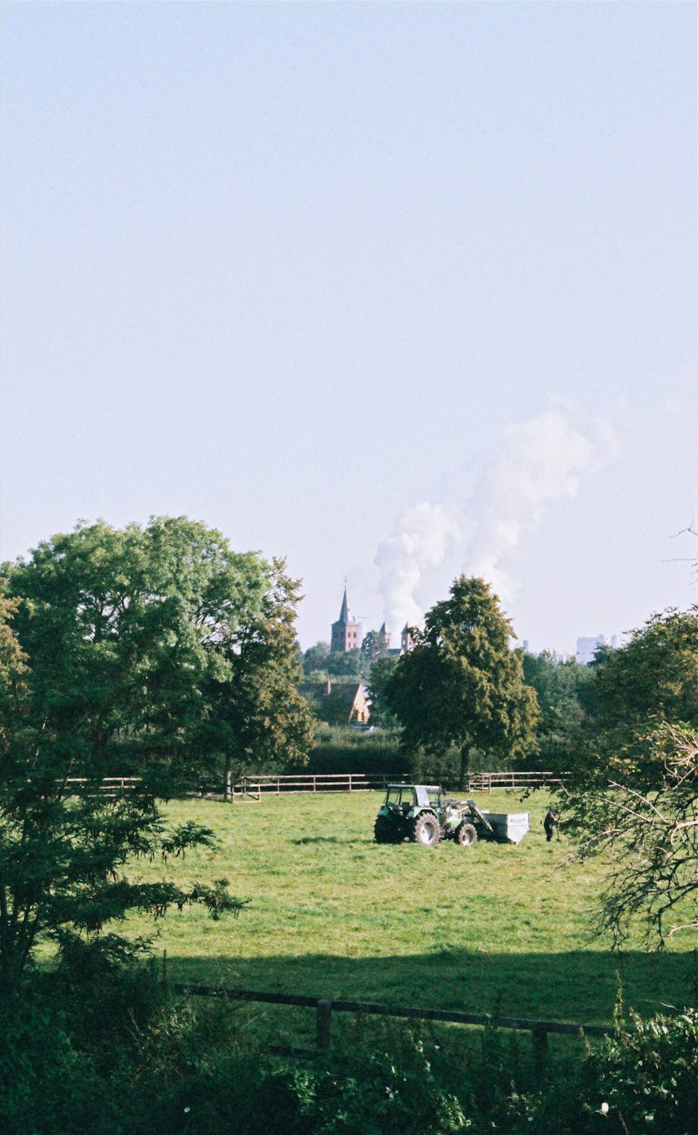 a field with a tractor in the middle of it