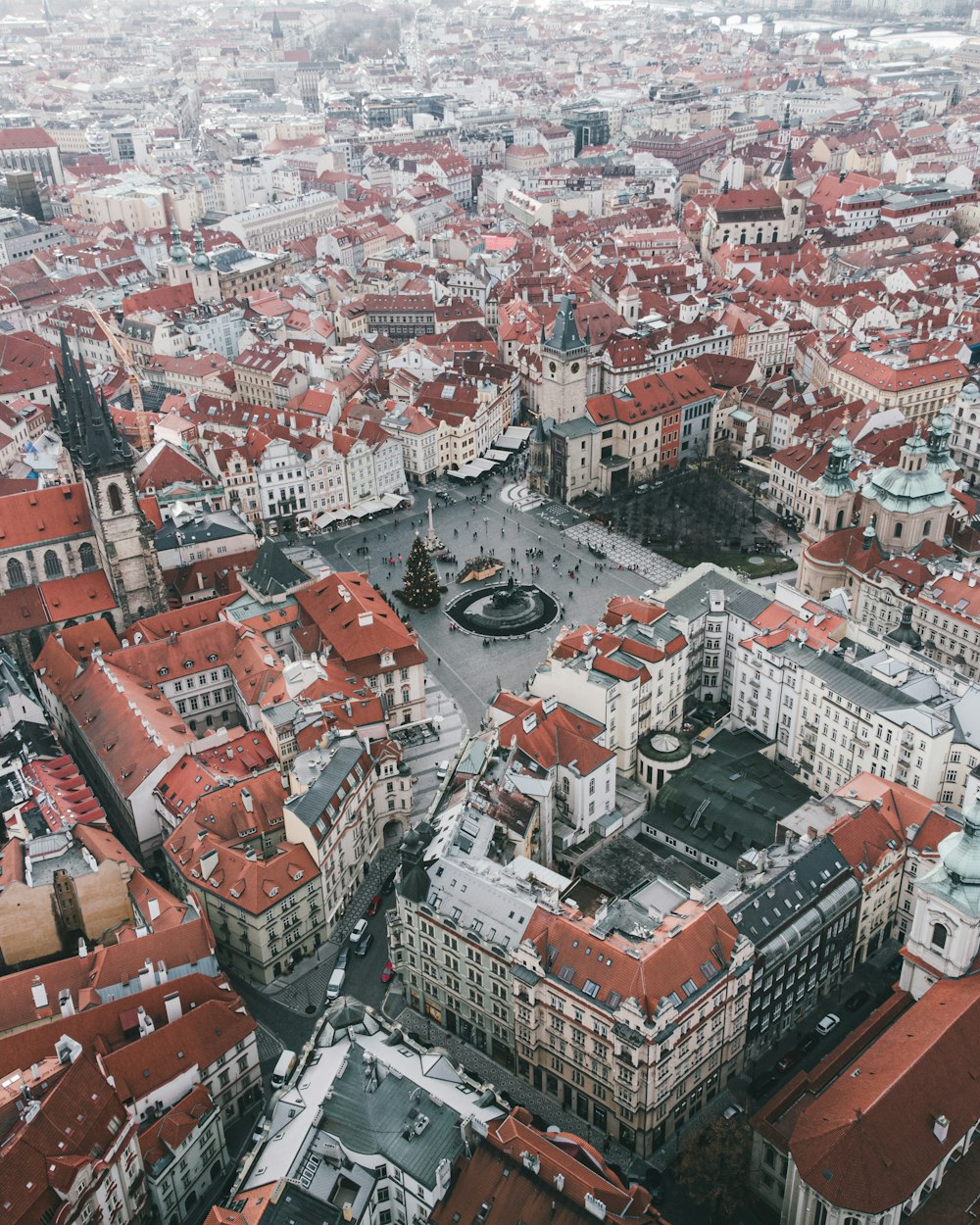 an aerial view of a city with red roofs