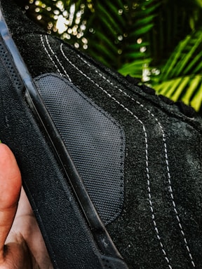 Close-up of a handcrafted sneaker with unique design details, set against an urban street backdrop.