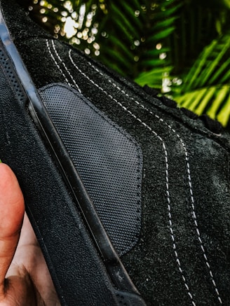 Close-up of breathable, textured fabric on a pair of modern joggers laid out on a concrete bench.
