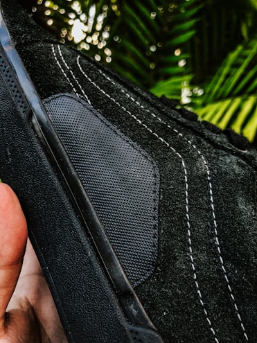 Close-up of breathable, textured fabric on a pair of modern joggers laid out on a concrete bench.