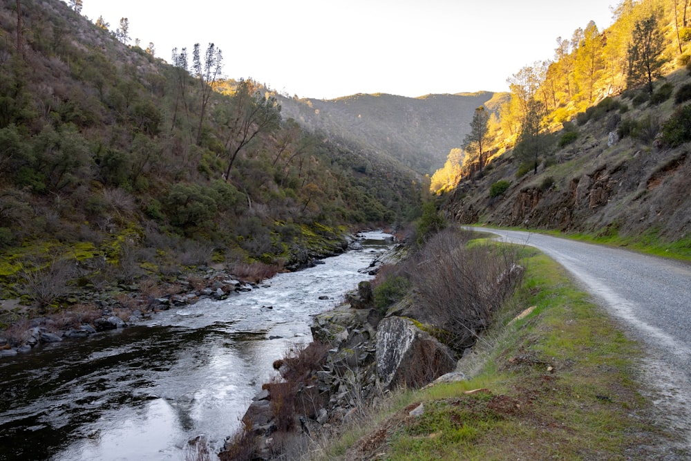 a river running through a lush green hillside