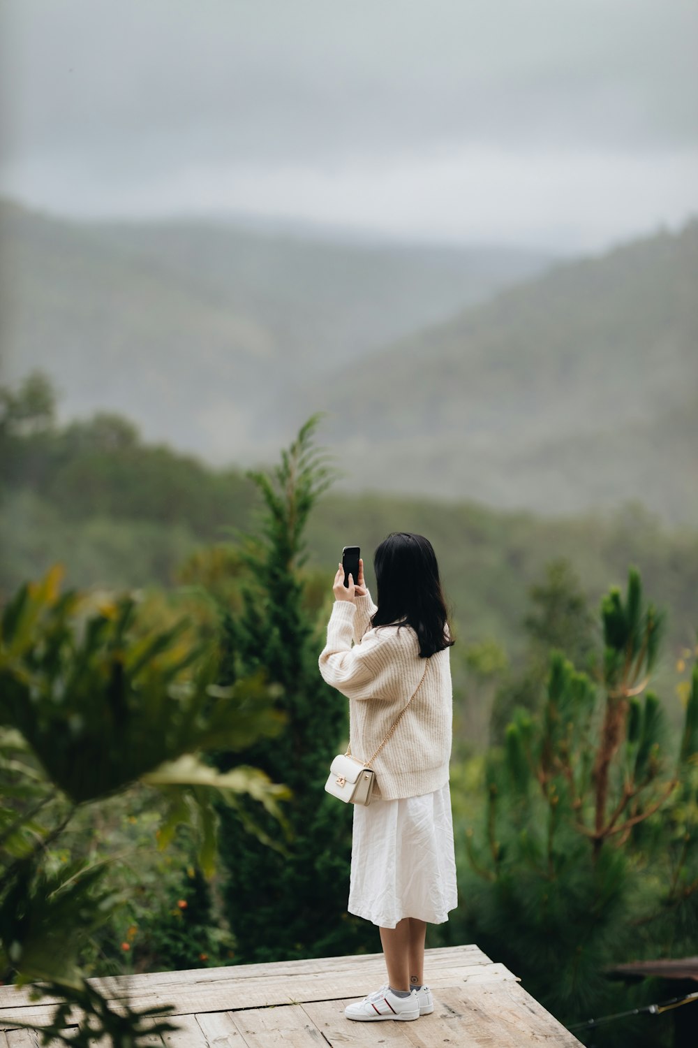 a woman taking a picture with her cell phone