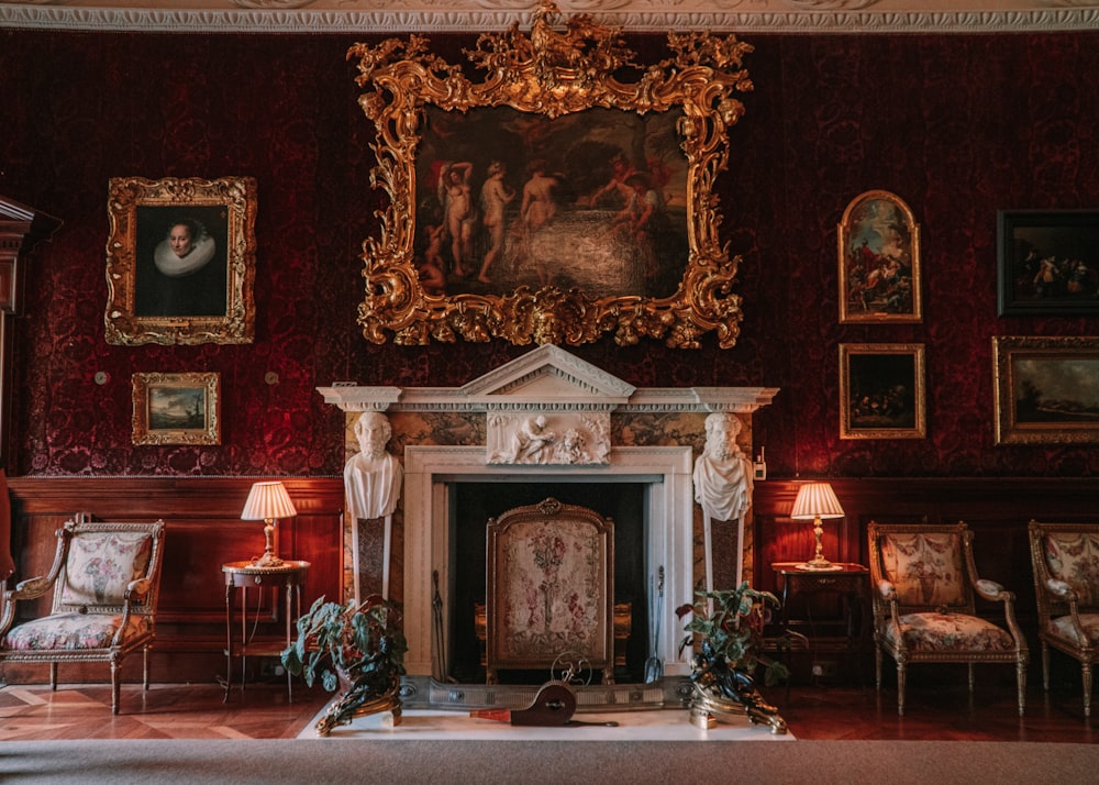 a room with a fireplace and paintings on the wall