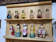 A variety of decorative light bulbs displayed artistically on a rustic shelf.