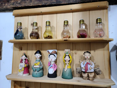 Decorative wooden creations displayed on a rustic shelf, blending playfulness and style.