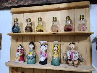 Decorative wooden creations displayed on a rustic shelf, blending playfulness and style.