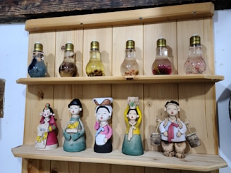 A variety of decorative light bulbs displayed artistically on a rustic shelf.