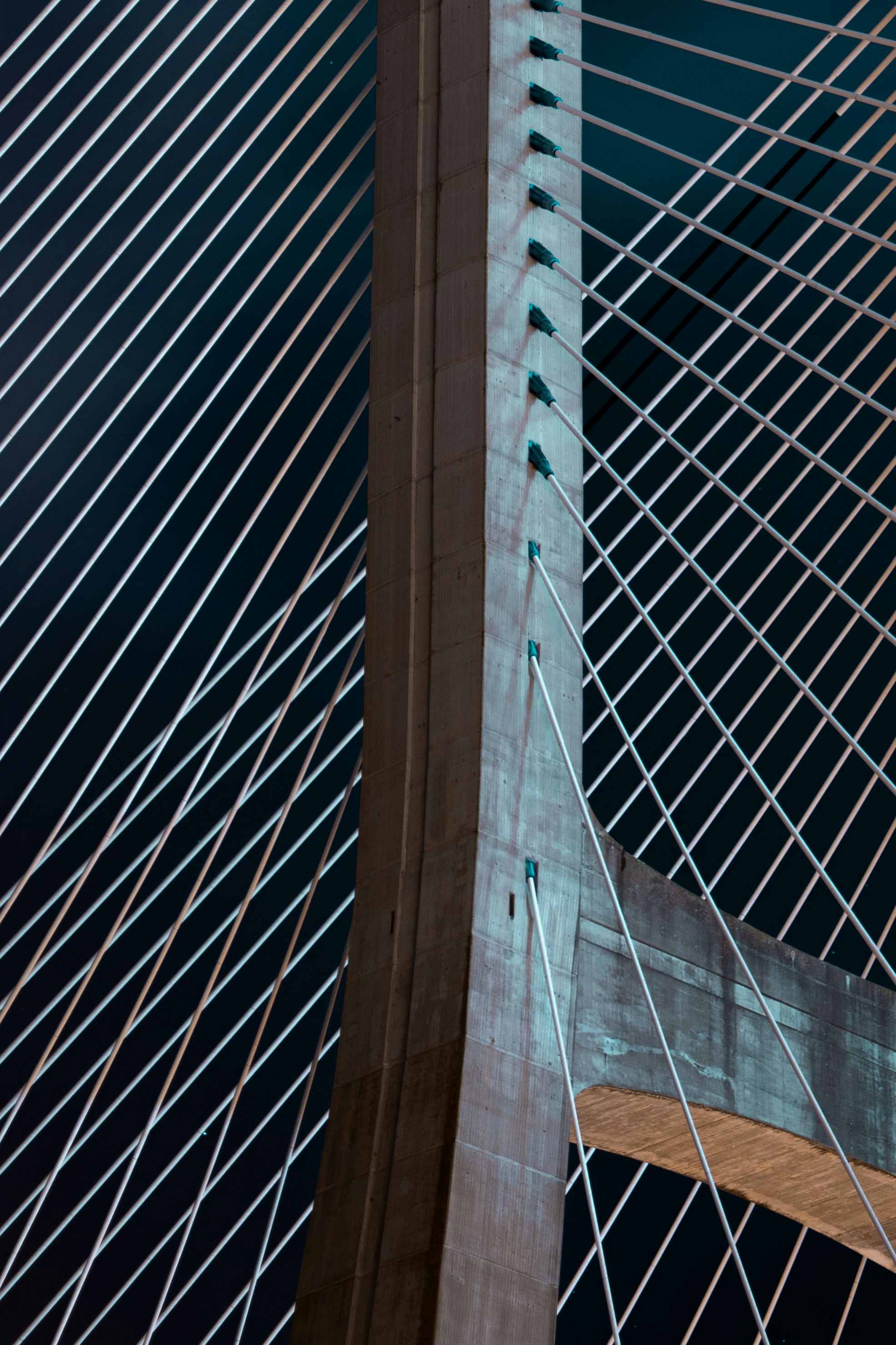a close up of a very tall bridge at night