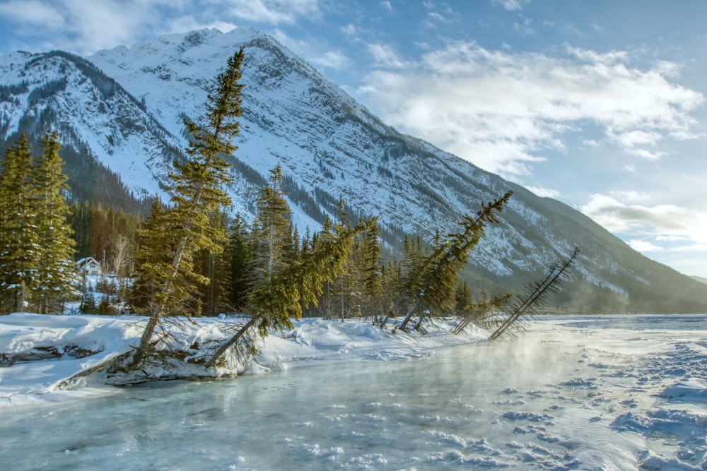 a frozen lake with a mountain in the background