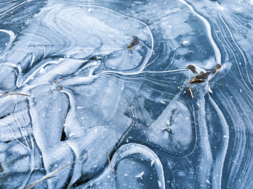 a close up of a frozen surface with water