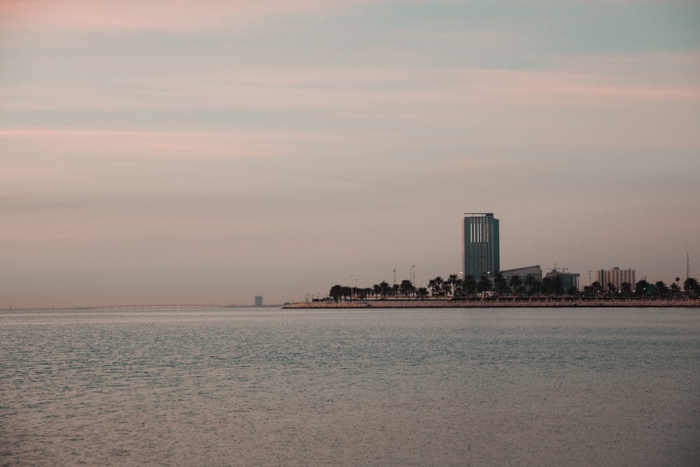 a large body of water with a city in the background