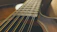 Close-up of a handcrafted guitar body showing fine wood grain and craftsmanship.