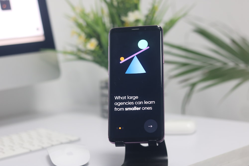 a cell phone on a stand on a desk