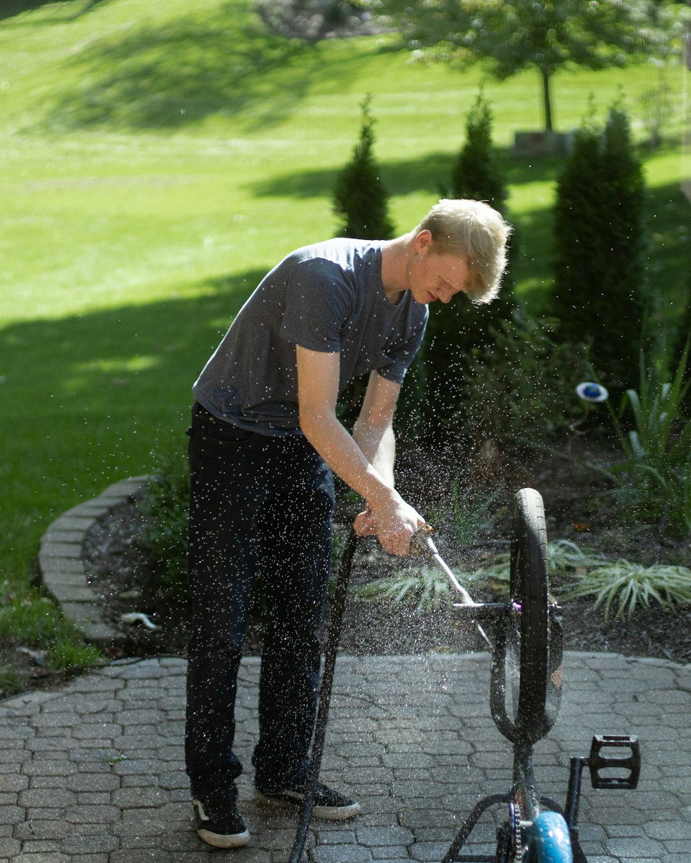 a man using a pressure washer on a patio
