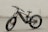 A black, modern fat-tire electric bike is positioned against a smooth, pale background. The bike features thick, rugged tires suitable for off-road terrain and a sleek carbon fiber frame. The battery and motor are integrated into the frame, highlighting its electric capability.