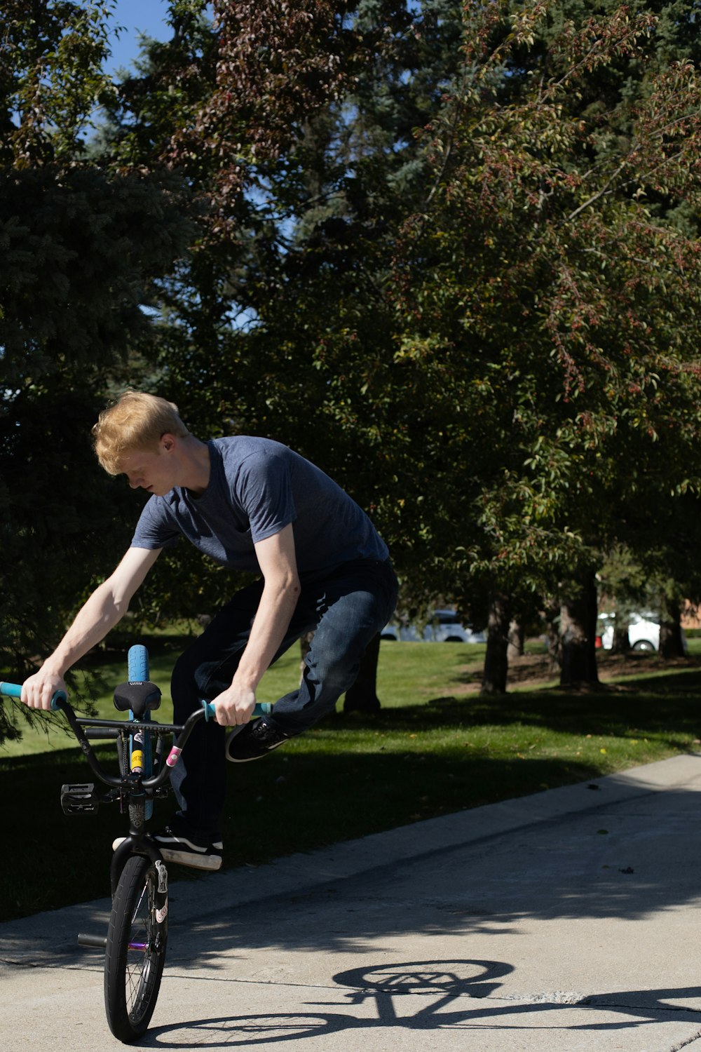 a man riding a bike down a sidewalk