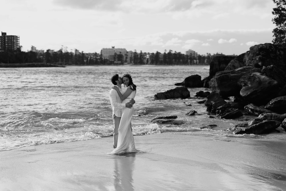 a couple of people that are standing in the sand