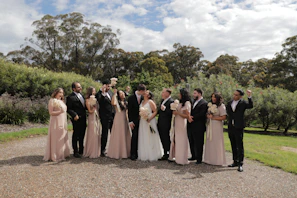 Bride and groom celebrating their wedding in the garden area surrounded by guests
