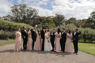 Bride and groom celebrating their wedding in the garden area surrounded by guests