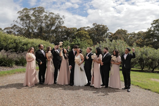 A group of people getting into a taxi outside a wedding venue.