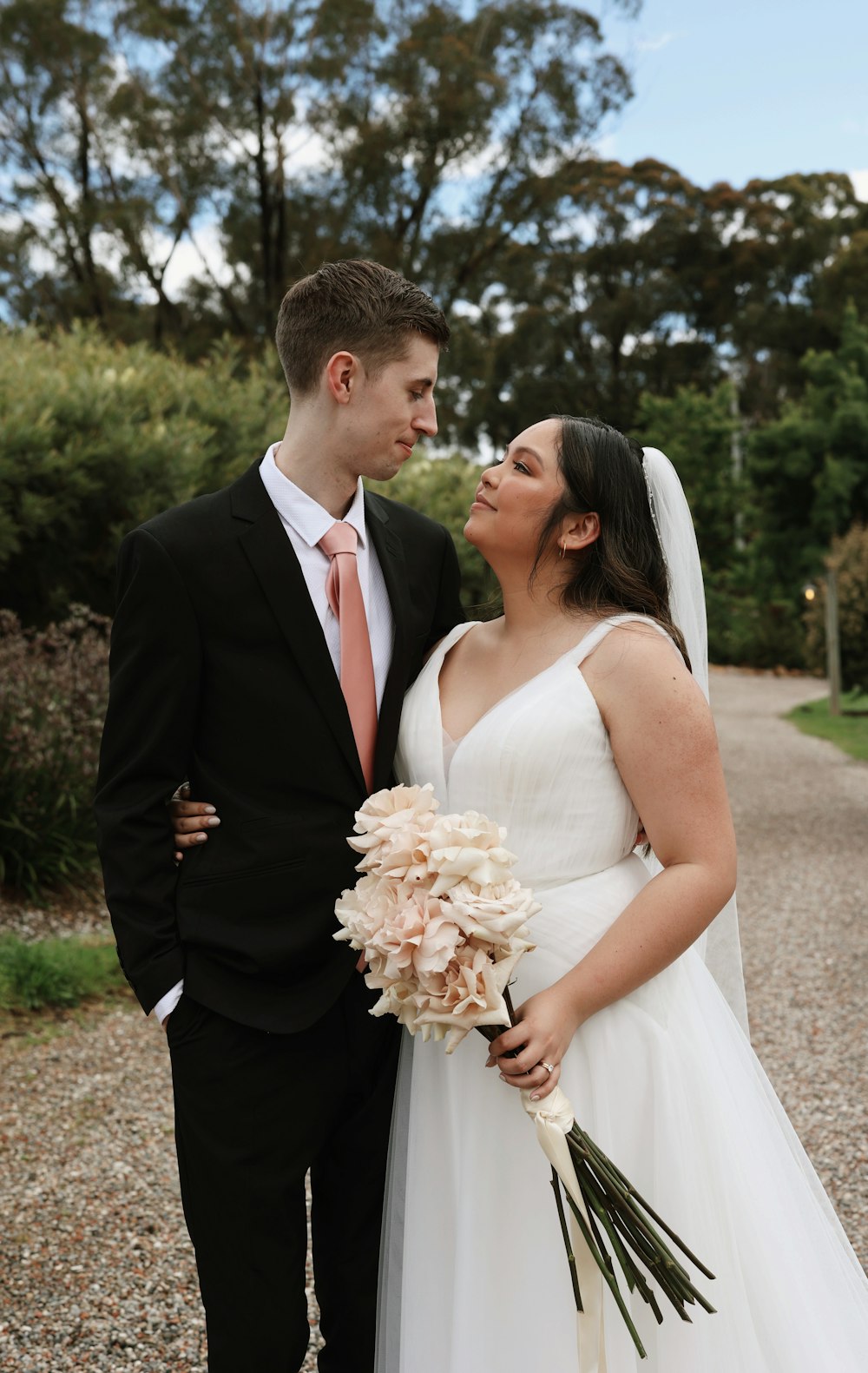 a bride and groom pose for a picture