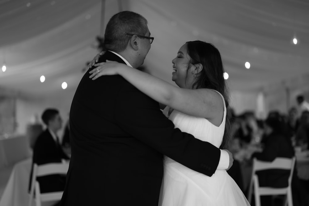 a man and a woman dance together in a tent