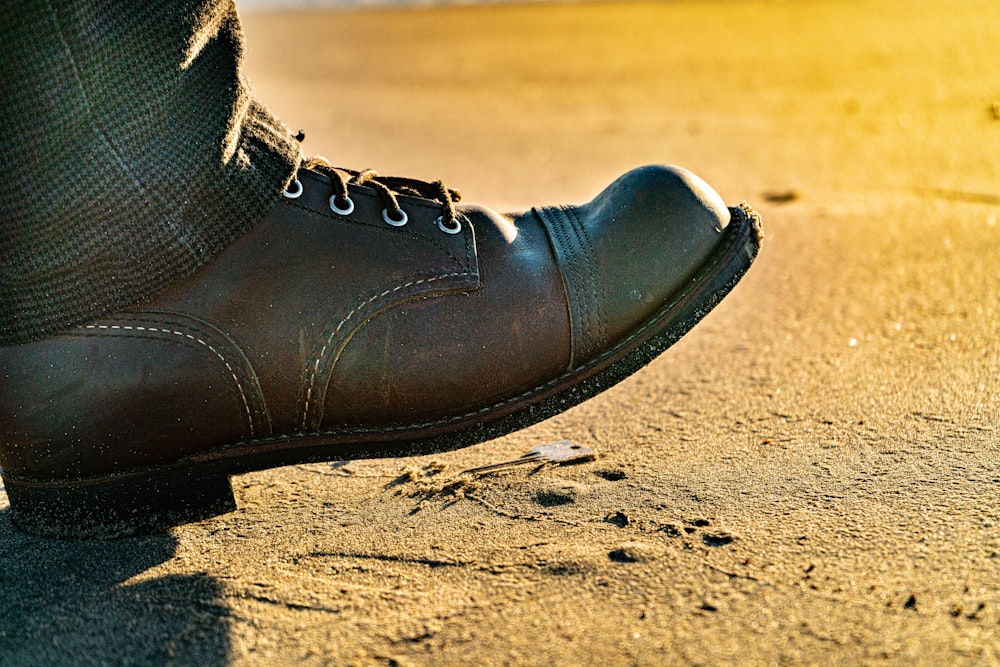 a close up of a person's shoes on the ground