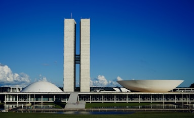 a large building with a tall tower next to a body of water