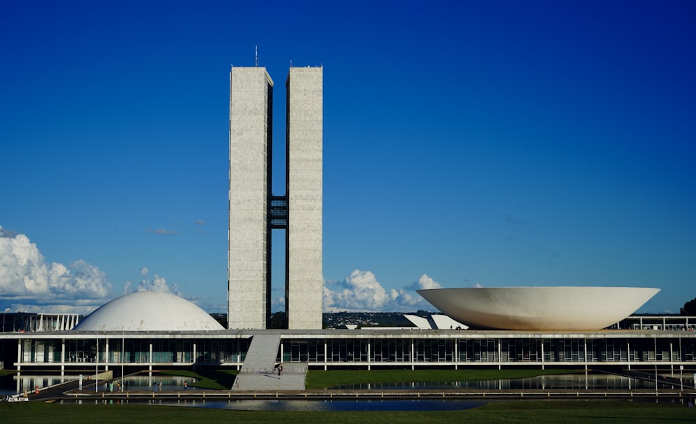 a large building with a tall tower next to a body of water