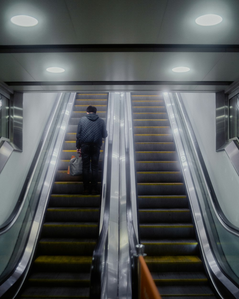 a man riding an escalator down a set of stairs