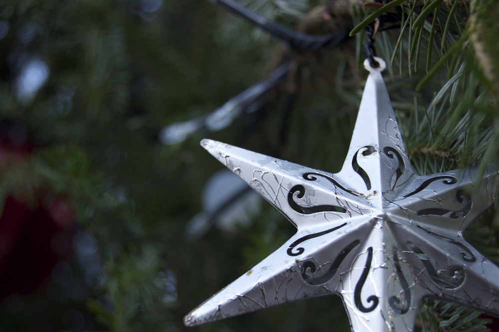 a white ornament hanging from a christmas tree