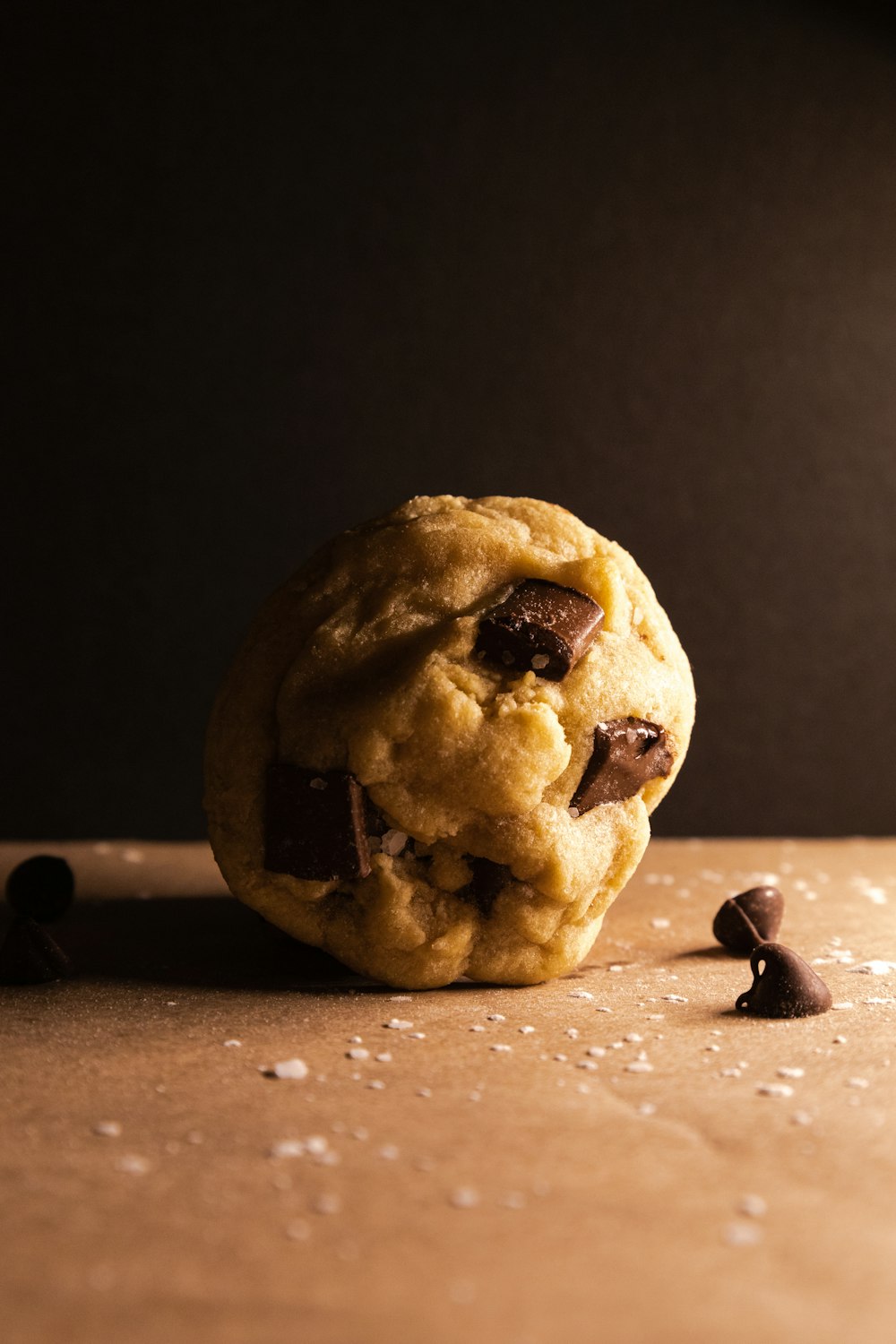 a cookie with chocolate chips on a table