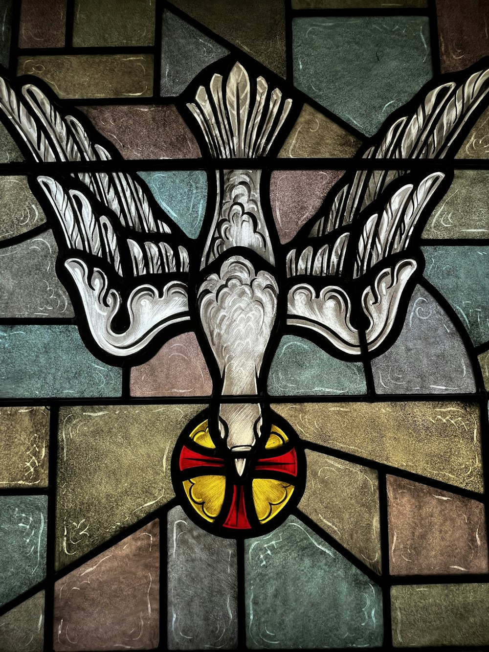 a stained glass window with a bird on it