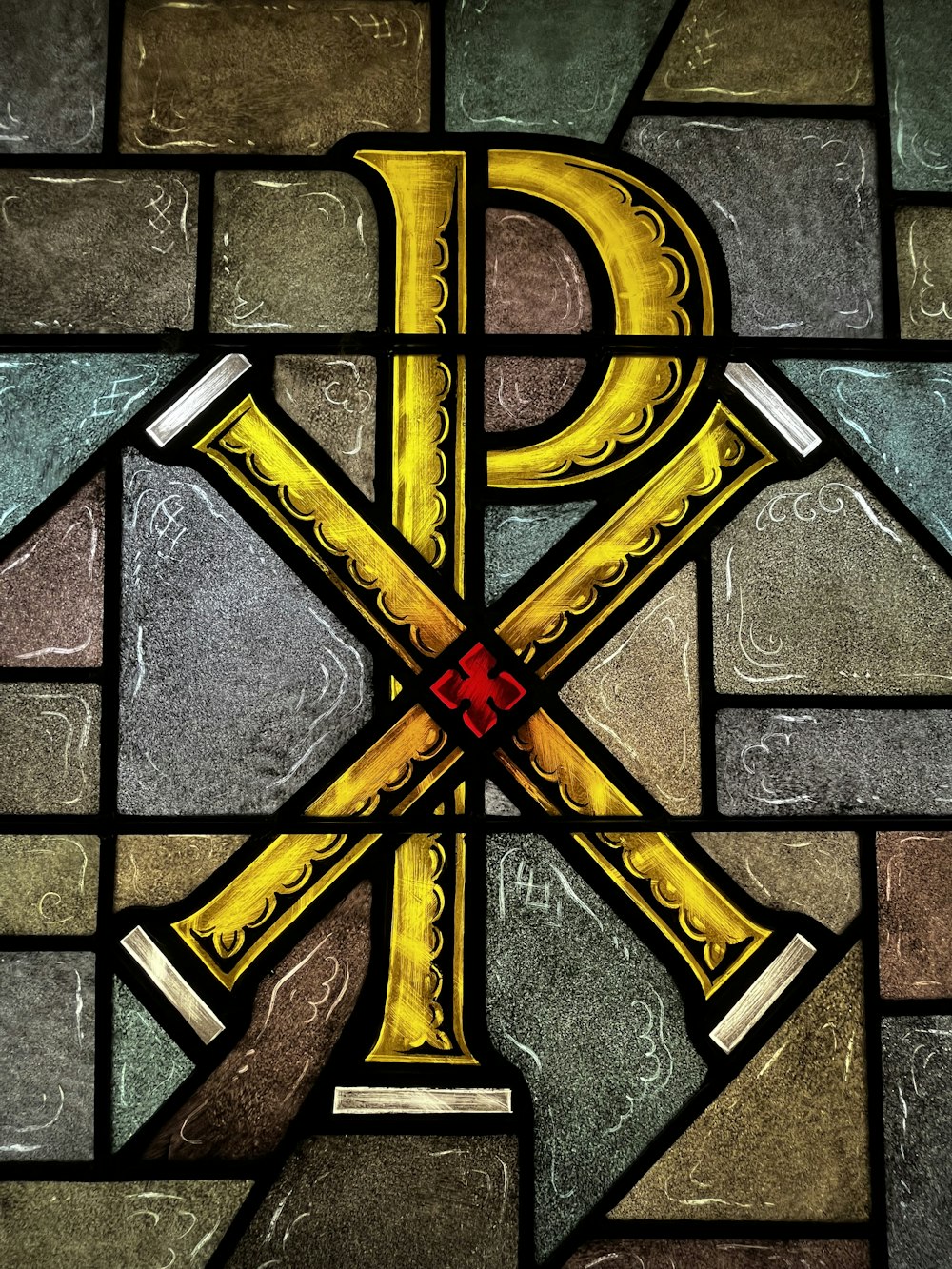 a close up of a stained glass window with letters